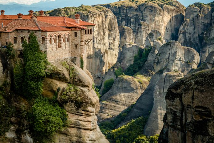Meteora monasteries and sandstone landscape — Voyazure Meteora monasteries rising above sandstone pillars in central Greece