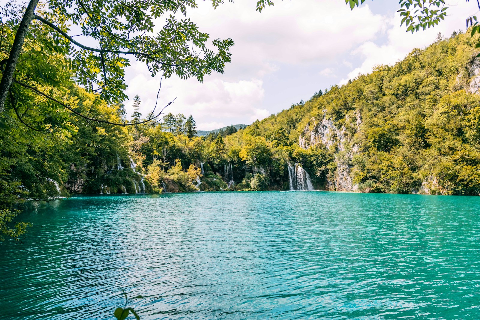 Plitvice Lakes slow nature journey — Voyazure Turquoise lake and waterfalls in the forest at Plitvice Lakes National Park