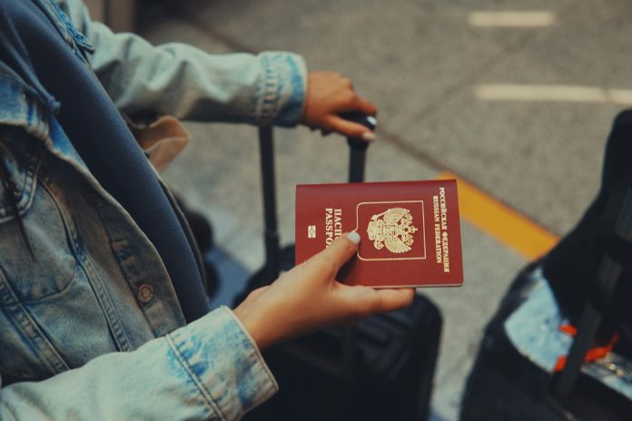 Travel documents for minors in Europe A traveller holding a passport before departure